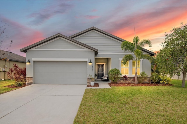 single story home with stone siding, concrete driveway, a front yard, and a garage