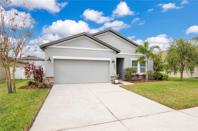 ranch-style home featuring a front yard, driveway, stucco siding, stone siding, and a garage
