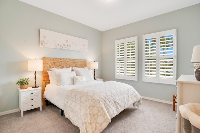 carpeted bedroom featuring baseboards