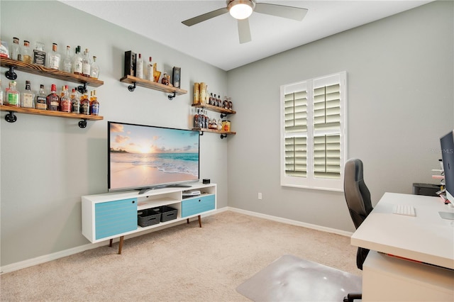 office space featuring a bar, baseboards, carpet floors, and ceiling fan