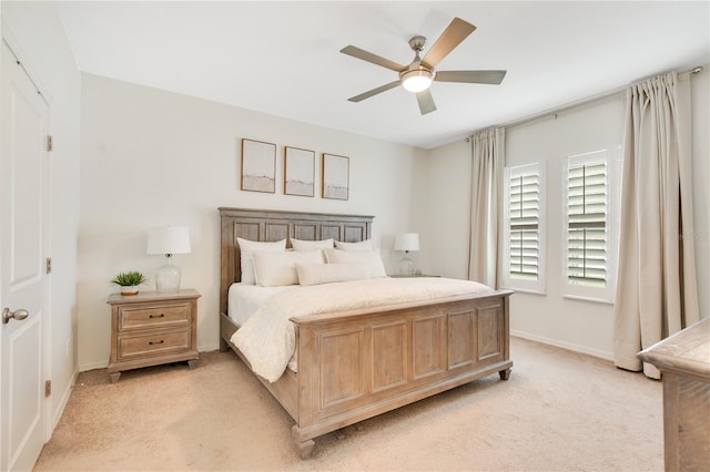 bedroom with baseboards, light carpet, and a ceiling fan