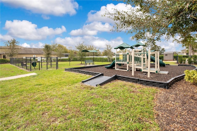 community play area with a yard and fence