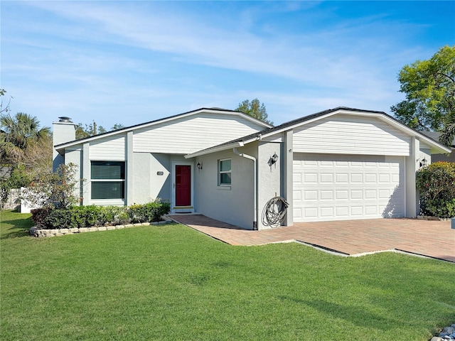 single story home featuring stucco siding, decorative driveway, a front yard, a garage, and a chimney