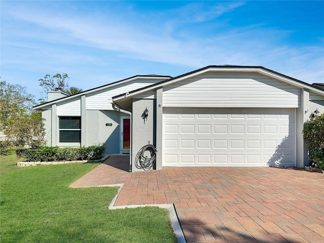 view of front facade with a garage, stucco siding, decorative driveway, and a front lawn