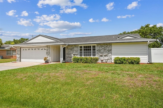 ranch-style house with a front yard, fence, driveway, stone siding, and a garage