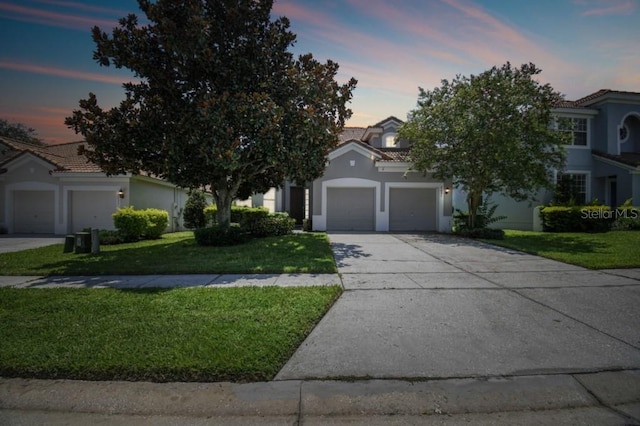 obstructed view of property with stucco siding, a yard, concrete driveway, an attached garage, and a tiled roof