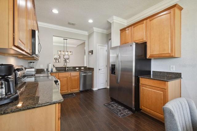 kitchen featuring dark wood-style floors, visible vents, dark stone counters, a sink, and stainless steel appliances