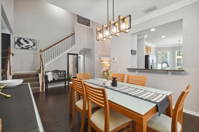 dining room with stairway, dark wood-style floors, visible vents, baseboards, and crown molding