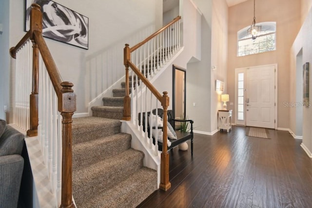 entryway with dark wood-style floors, baseboards, and a wealth of natural light