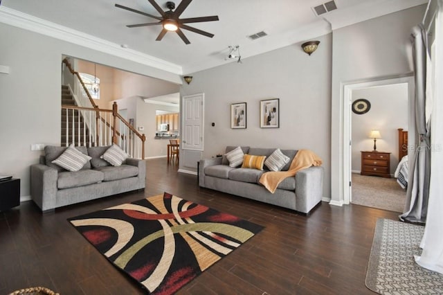 living area with stairs, wood finished floors, visible vents, and baseboards