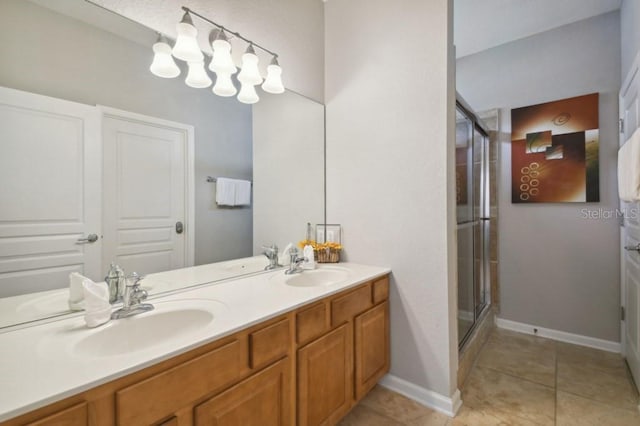 full bathroom with a sink, double vanity, a shower stall, and tile patterned floors