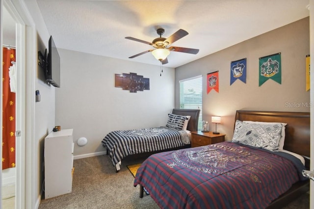 carpeted bedroom featuring baseboards and ceiling fan