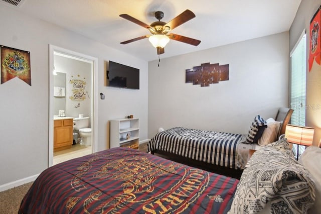 bedroom featuring visible vents, ceiling fan, baseboards, light carpet, and ensuite bathroom