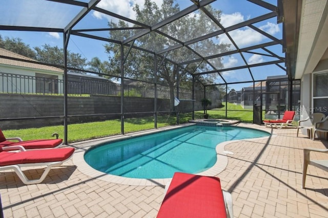 view of swimming pool featuring a lanai, a patio area, fence, and a pool with connected hot tub