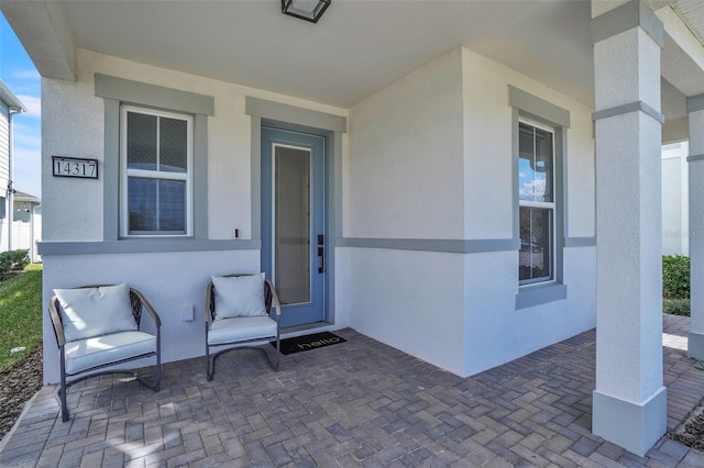 doorway to property with a patio area and stucco siding