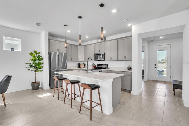 kitchen with visible vents, gray cabinets, and stainless steel appliances