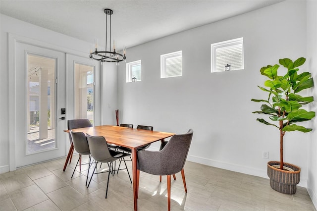 dining room featuring baseboards and a notable chandelier