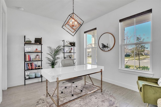 office area featuring a notable chandelier, baseboards, and light wood finished floors