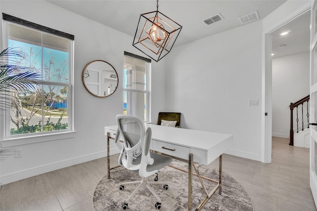 office space featuring a notable chandelier, visible vents, and baseboards