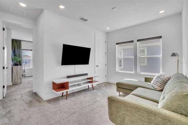 carpeted living room featuring visible vents, recessed lighting, and baseboards