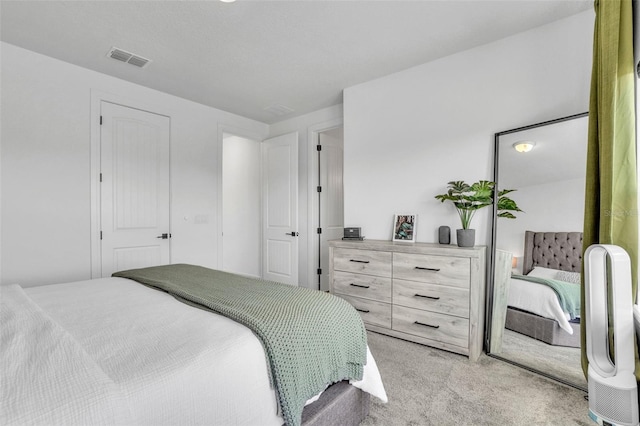 bedroom with visible vents and light colored carpet