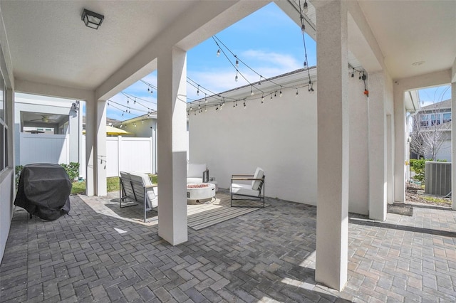 view of patio with a fire pit and fence