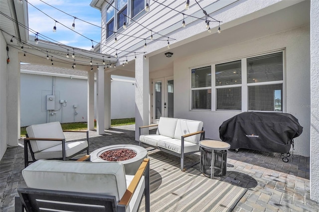 view of patio featuring grilling area and an outdoor living space with a fire pit