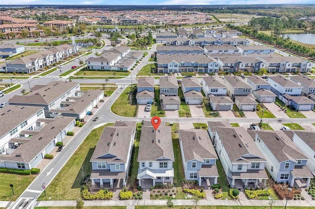 drone / aerial view featuring a residential view and a water view