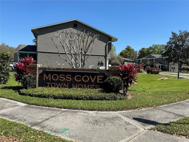 community / neighborhood sign with a lawn