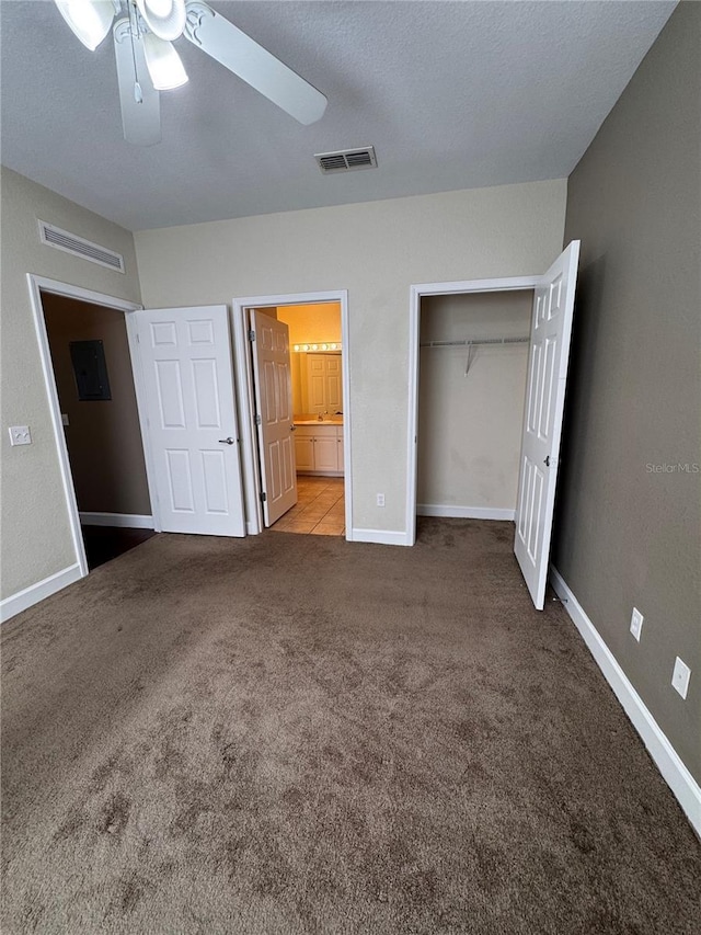 unfurnished bedroom featuring visible vents, baseboards, carpet flooring, a closet, and a textured ceiling