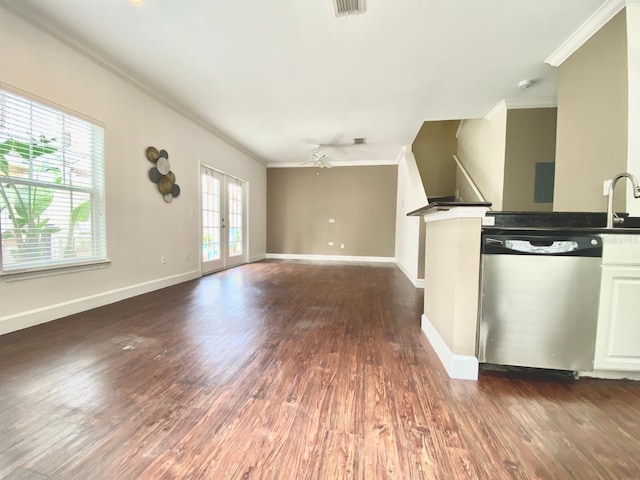 unfurnished living room featuring ceiling fan, baseboards, ornamental molding, and dark wood finished floors