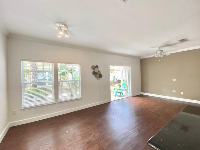 unfurnished living room with baseboards, dark wood-style floors, and ornamental molding