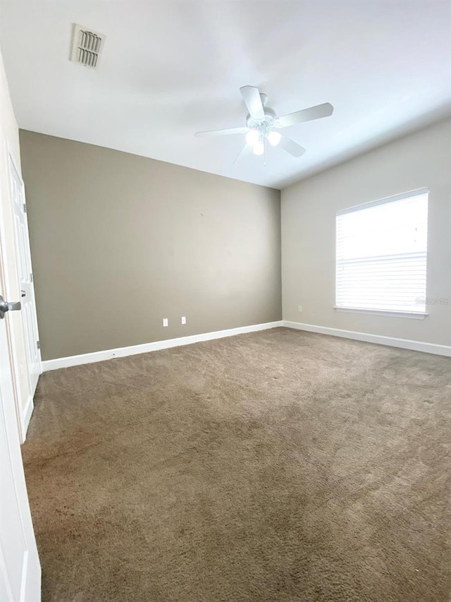 unfurnished room with visible vents, ceiling fan, baseboards, and carpet floors