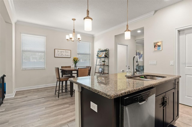 kitchen featuring stainless steel dishwasher, pendant lighting, ornamental molding, and a sink