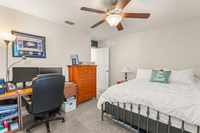 carpeted bedroom with visible vents and a ceiling fan