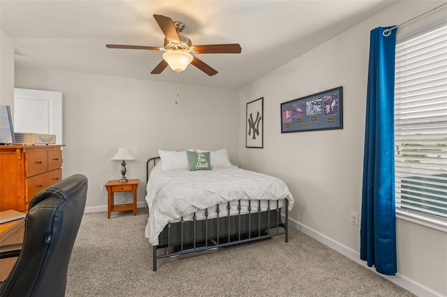 carpeted bedroom with a ceiling fan and baseboards