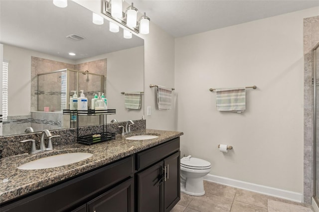 bathroom featuring a sink, toilet, a stall shower, and tile patterned flooring