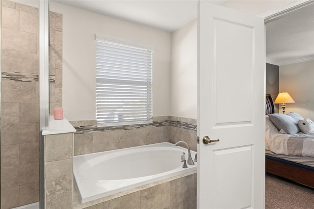 bathroom featuring ensuite bathroom, a garden tub, and ornamental molding