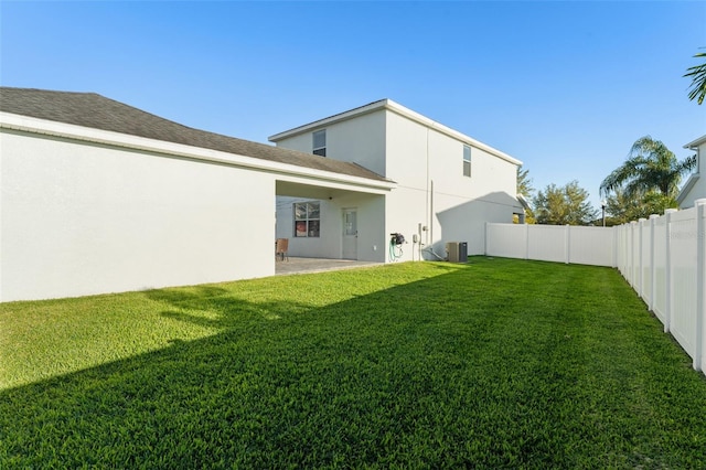 view of yard featuring a patio area, central air condition unit, and a fenced backyard