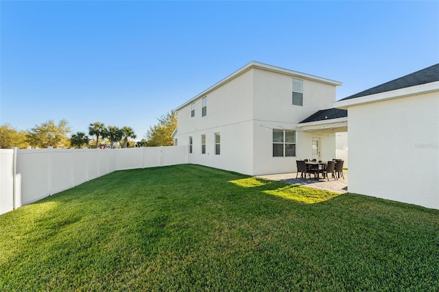 exterior space featuring a lawn, a patio, a fenced backyard, and stucco siding