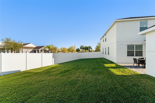 view of yard with a patio area and a fenced backyard