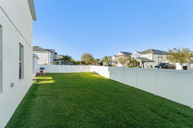 view of yard with a residential view and a fenced backyard