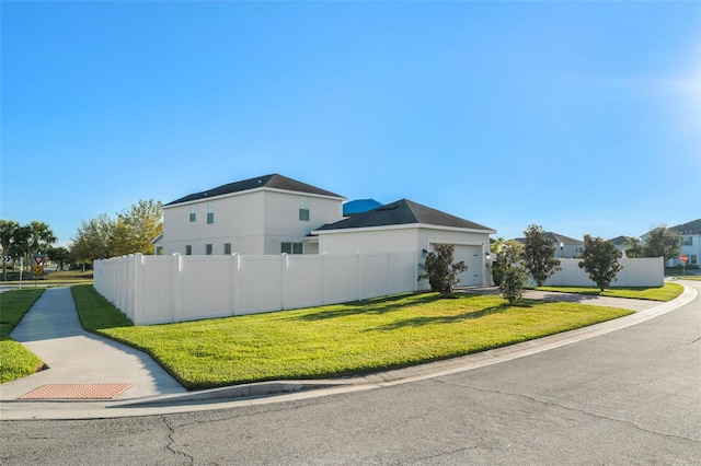 view of property exterior featuring a garage, a yard, and fence