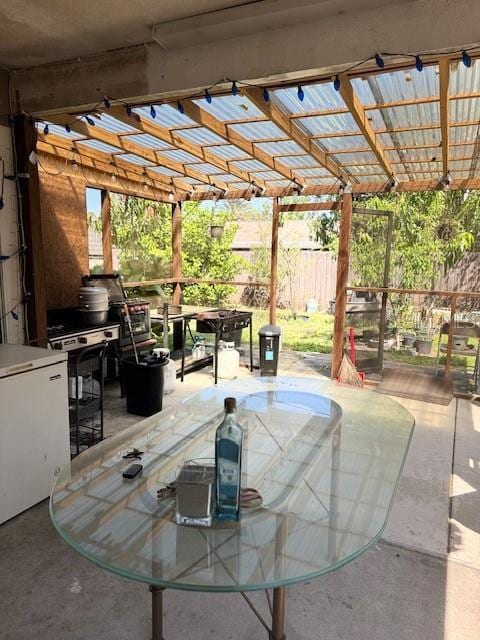 view of patio / terrace with outdoor dining space, a pergola, and fence