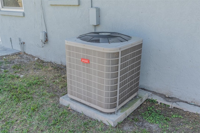 exterior details featuring stucco siding and central AC