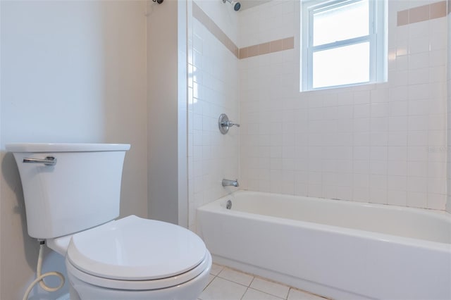 bathroom with tile patterned floors, toilet, and bathing tub / shower combination