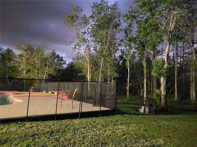 view of home's community featuring a yard and fence