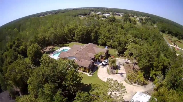 drone / aerial view with a wooded view