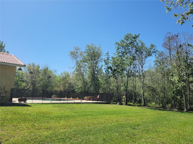 view of yard featuring a fenced in pool and fence