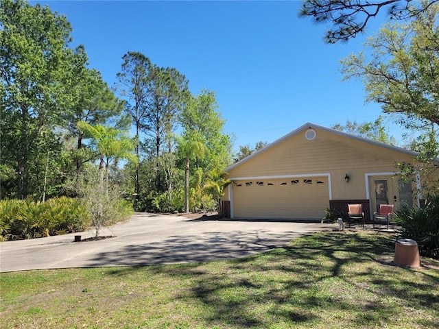 view of property exterior featuring concrete driveway, an attached garage, a lawn, and brick siding